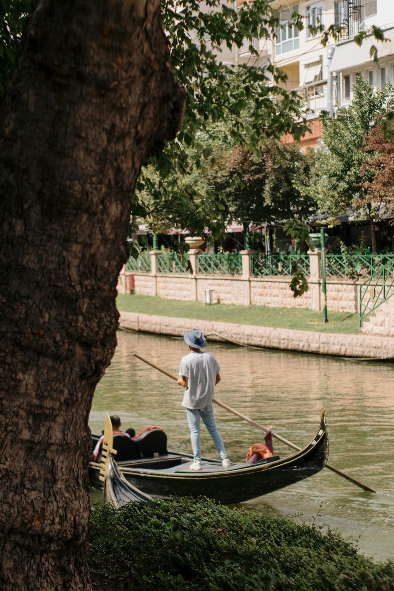 A serene gondola ride on Porsuk Stream featuring a gondolier in Eskişehir, Turkey.