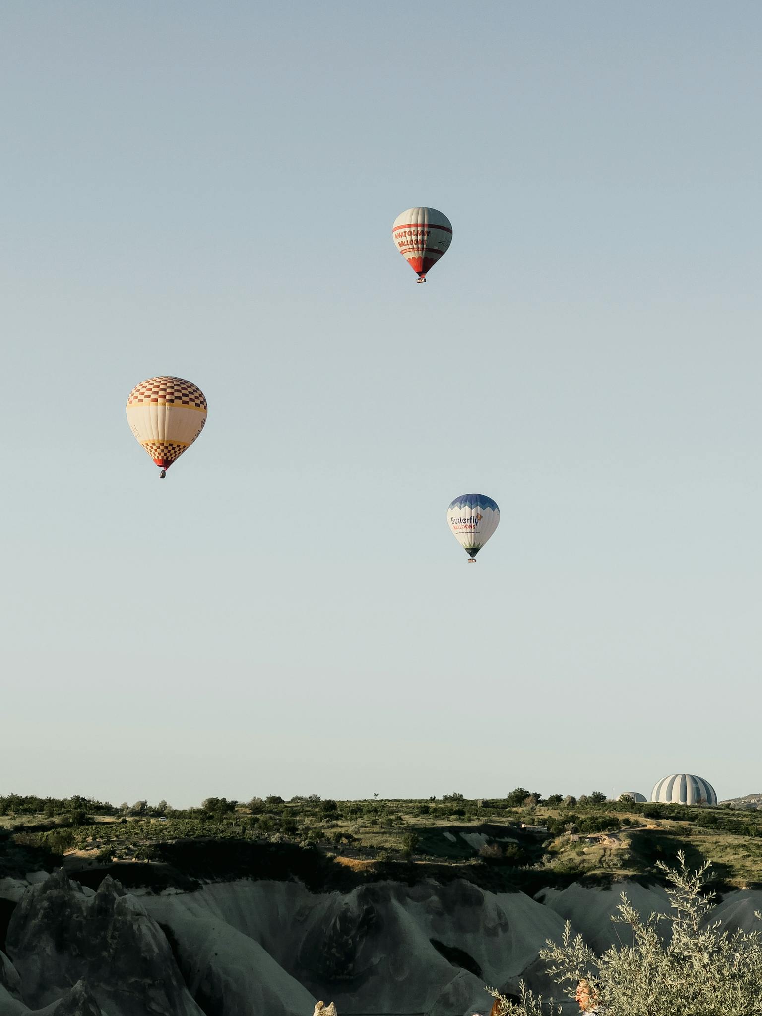 Hot air balloons soar over the unique landscapes of Cappadocia, Turkey, offering an adventurous travel experience.