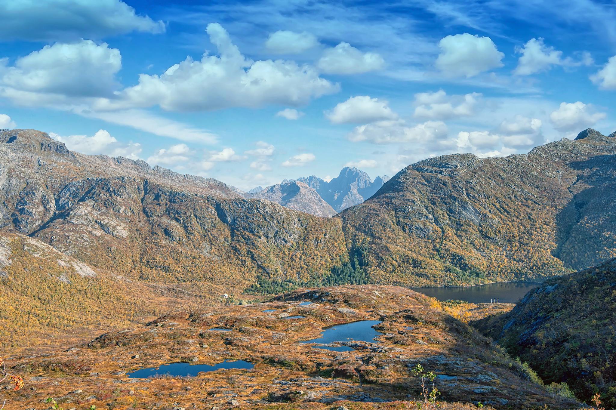 Stunning view of the autumn landscape in Lofoten, Norway with mountains and blue skies.